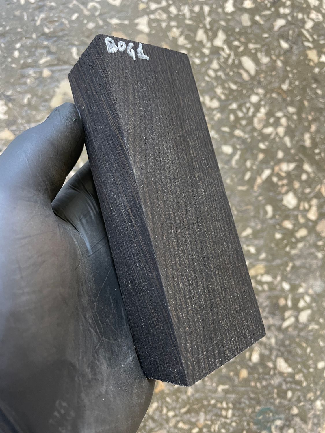 Stabilized bog oak knife scales with deep black color and natural ancient wood grain, matched pair for custom knife handles.