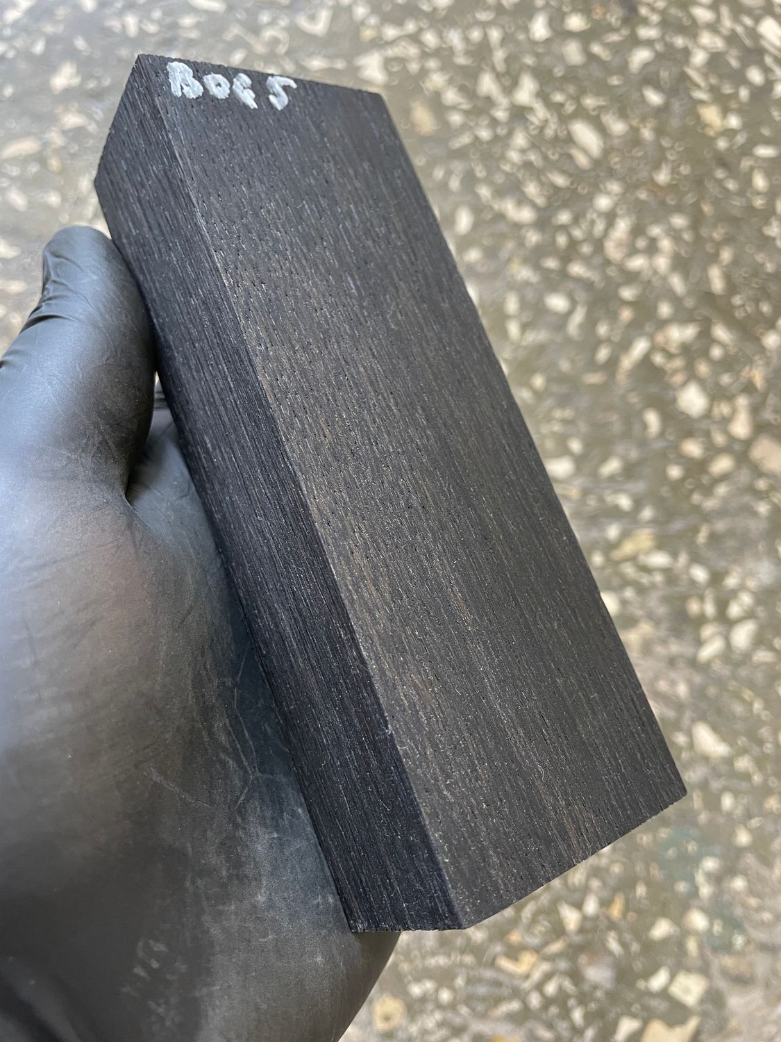 Stabilized bog oak knife scales with deep black color and natural ancient wood grain, matched pair for custom knife handles.