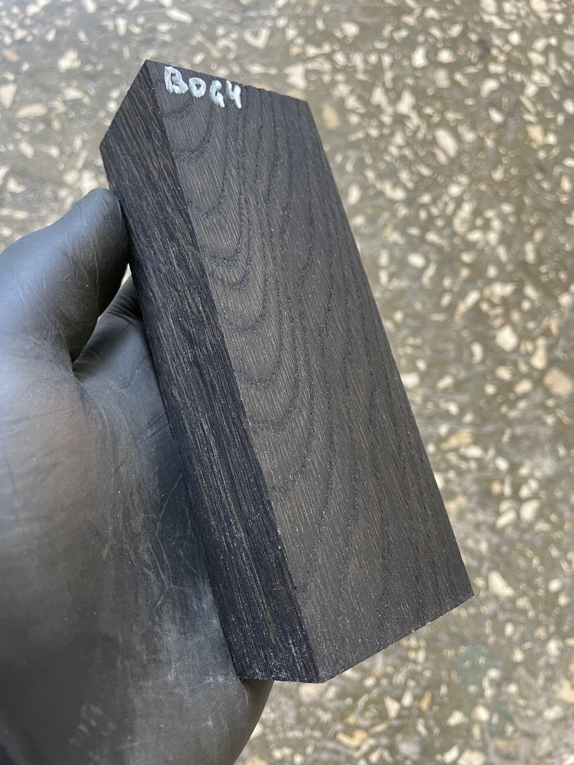 Stabilized bog oak knife scales with deep black color and natural ancient wood grain, matched pair for custom knife handles.