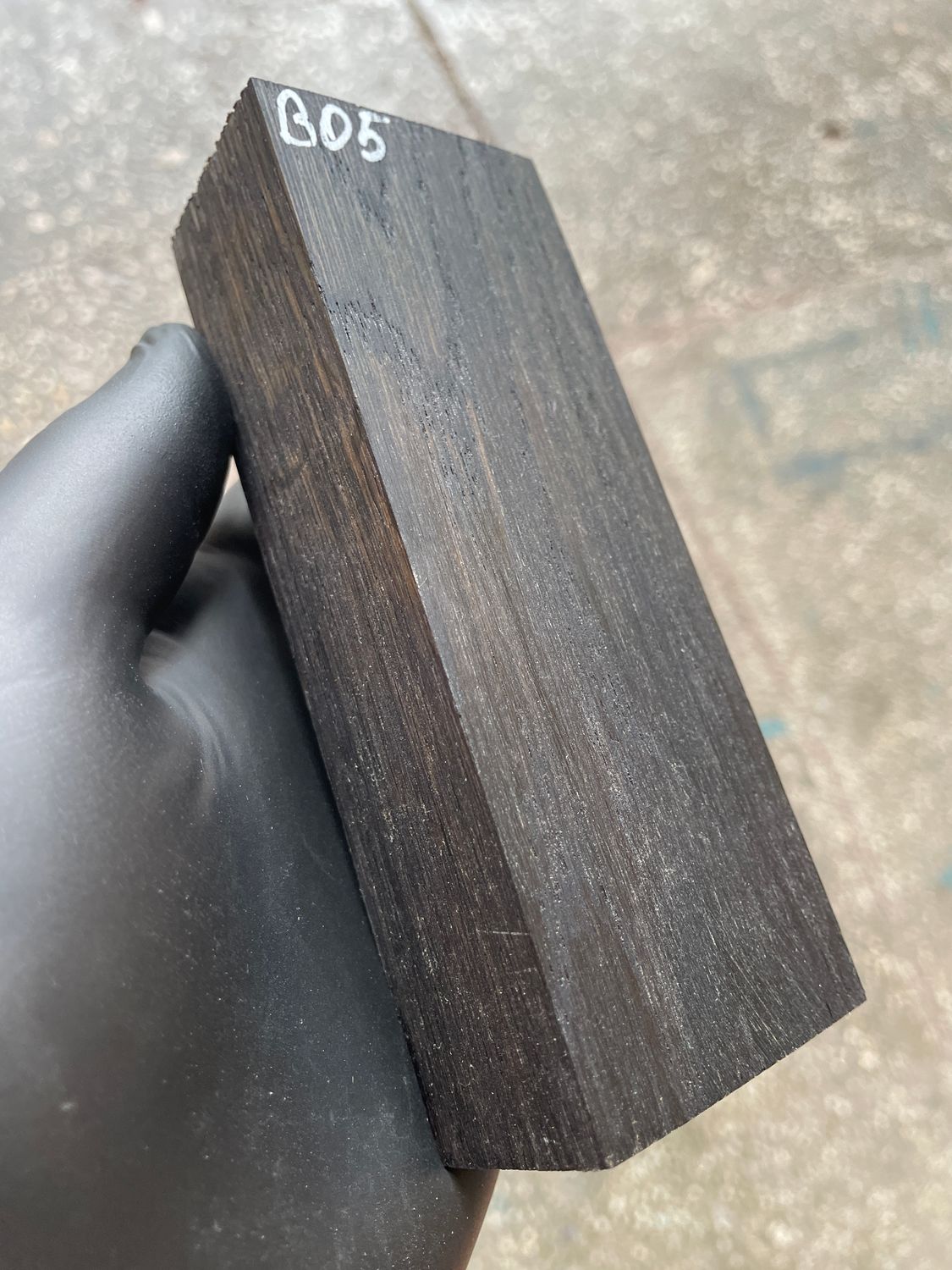 Stabilized bog oak knife scales with deep black color and natural ancient wood grain, matched pair for custom knife handles.