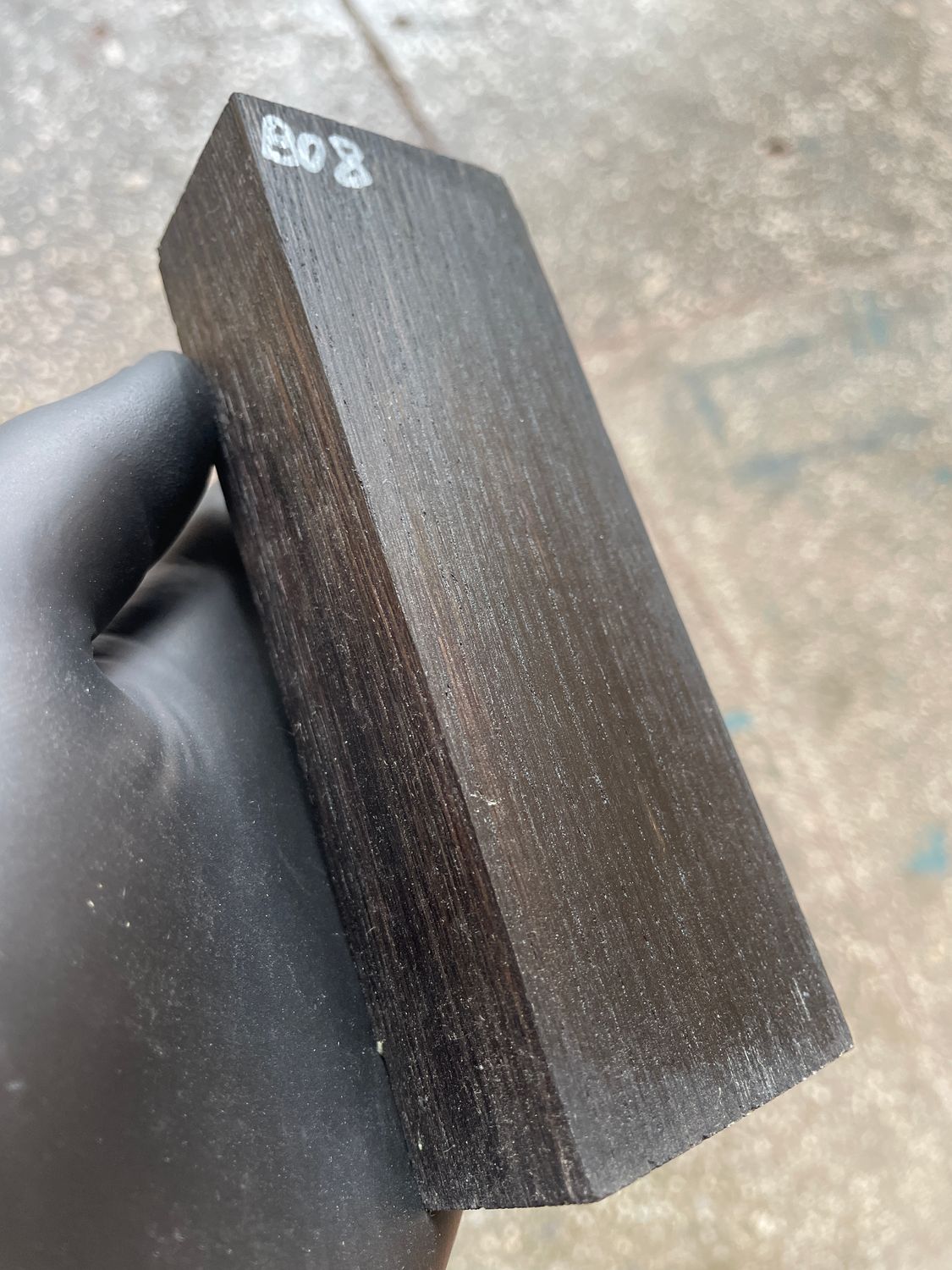 Stabilized bog oak knife scales with deep black color and natural ancient wood grain, matched pair for custom knife handles.