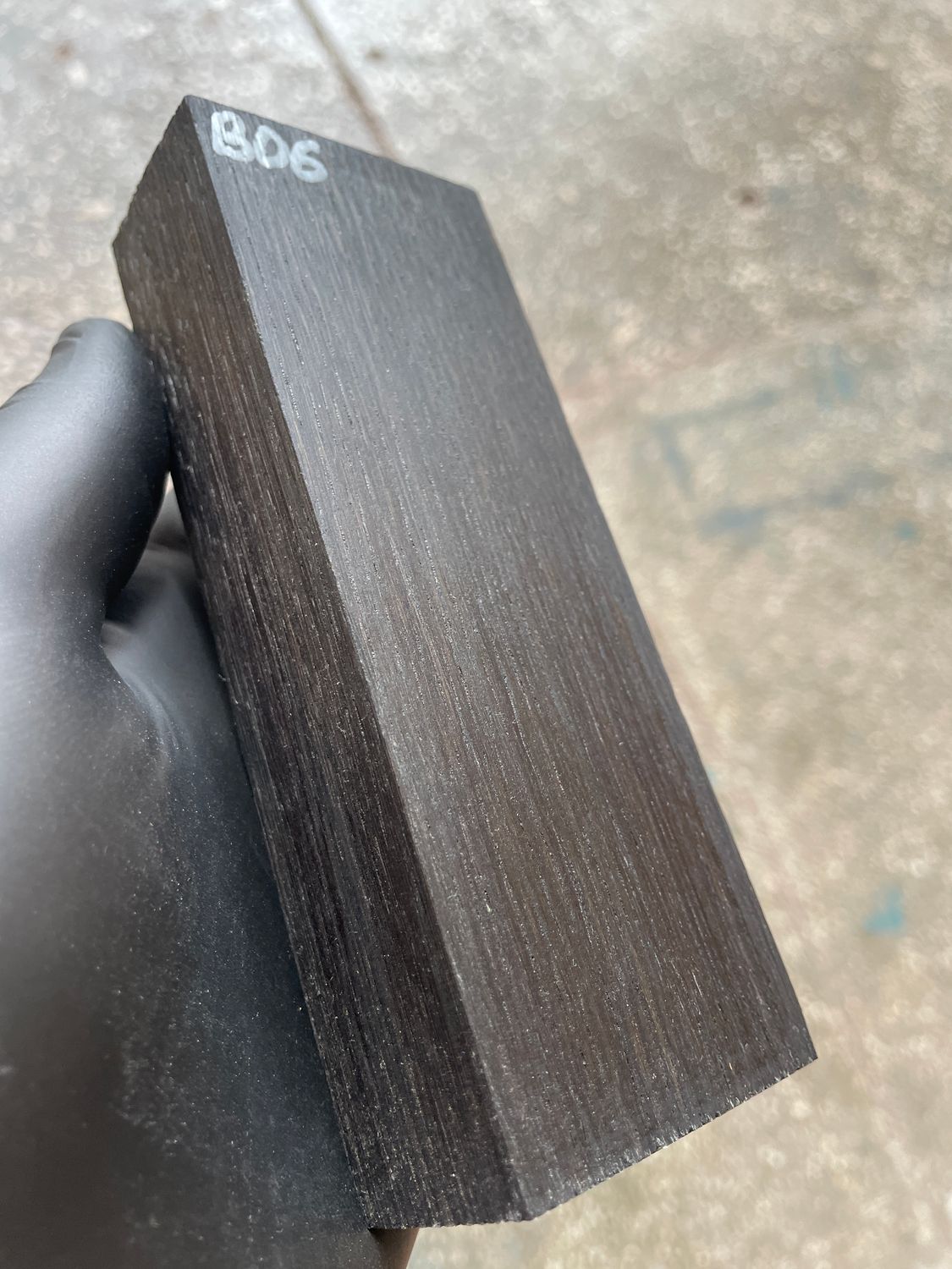 Stabilized bog oak knife scales with deep black color and natural ancient wood grain, matched pair for custom knife handles.