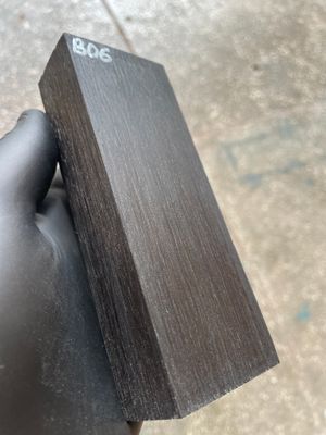Stabilized bog oak knife scales with deep black color and natural ancient wood grain, matched pair for custom knife handles.