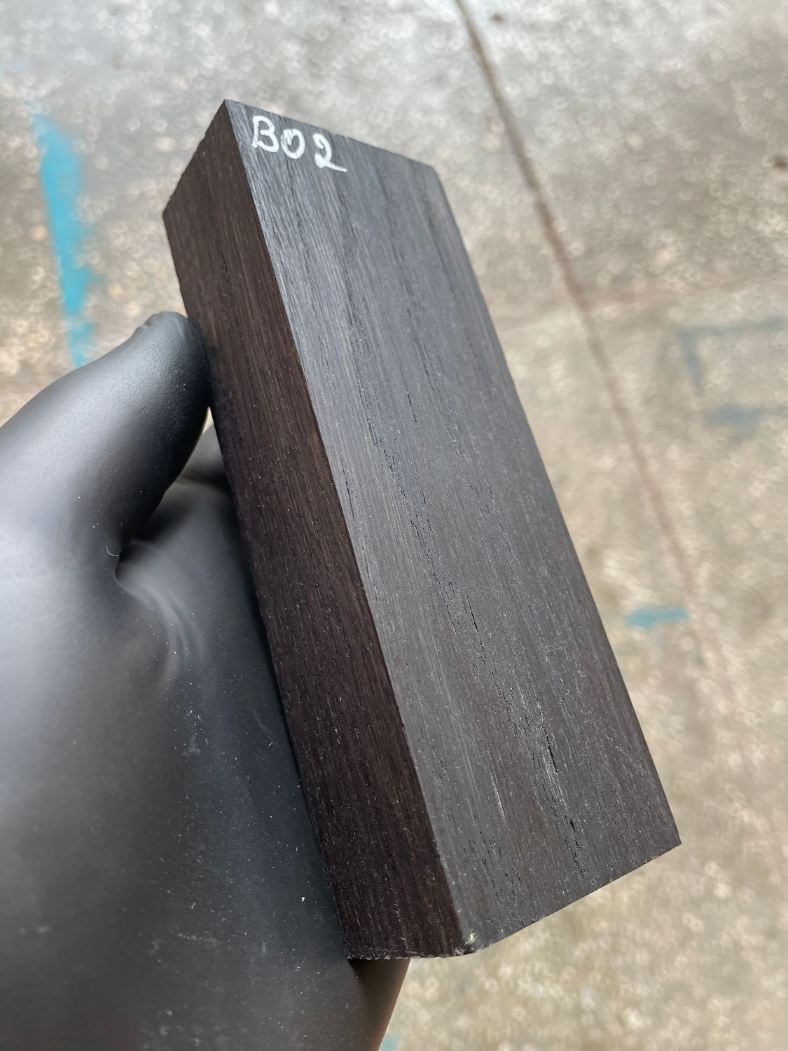 Stabilized bog oak knife scales with deep black color and natural ancient wood grain, matched pair for custom knife handles.