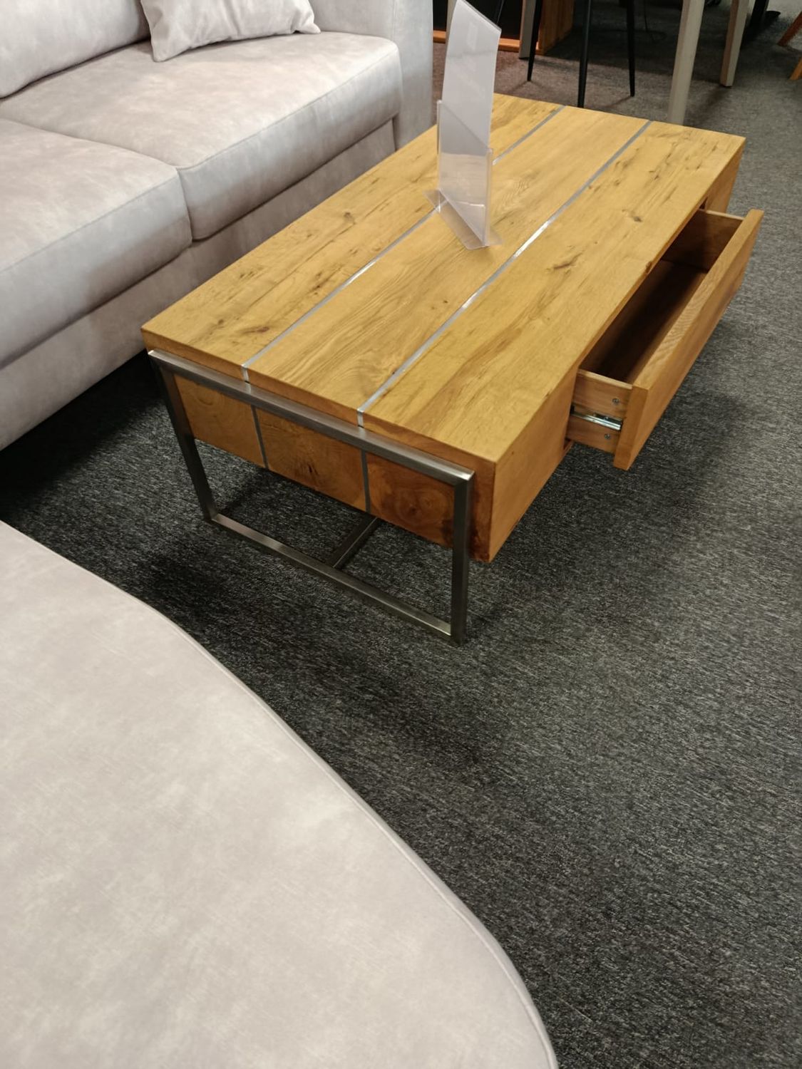 Oak coffee table with metal accents. Dimensions: 110 x 60 cm. Height: 42 cm. Coffee table with a drawer. On sale. 