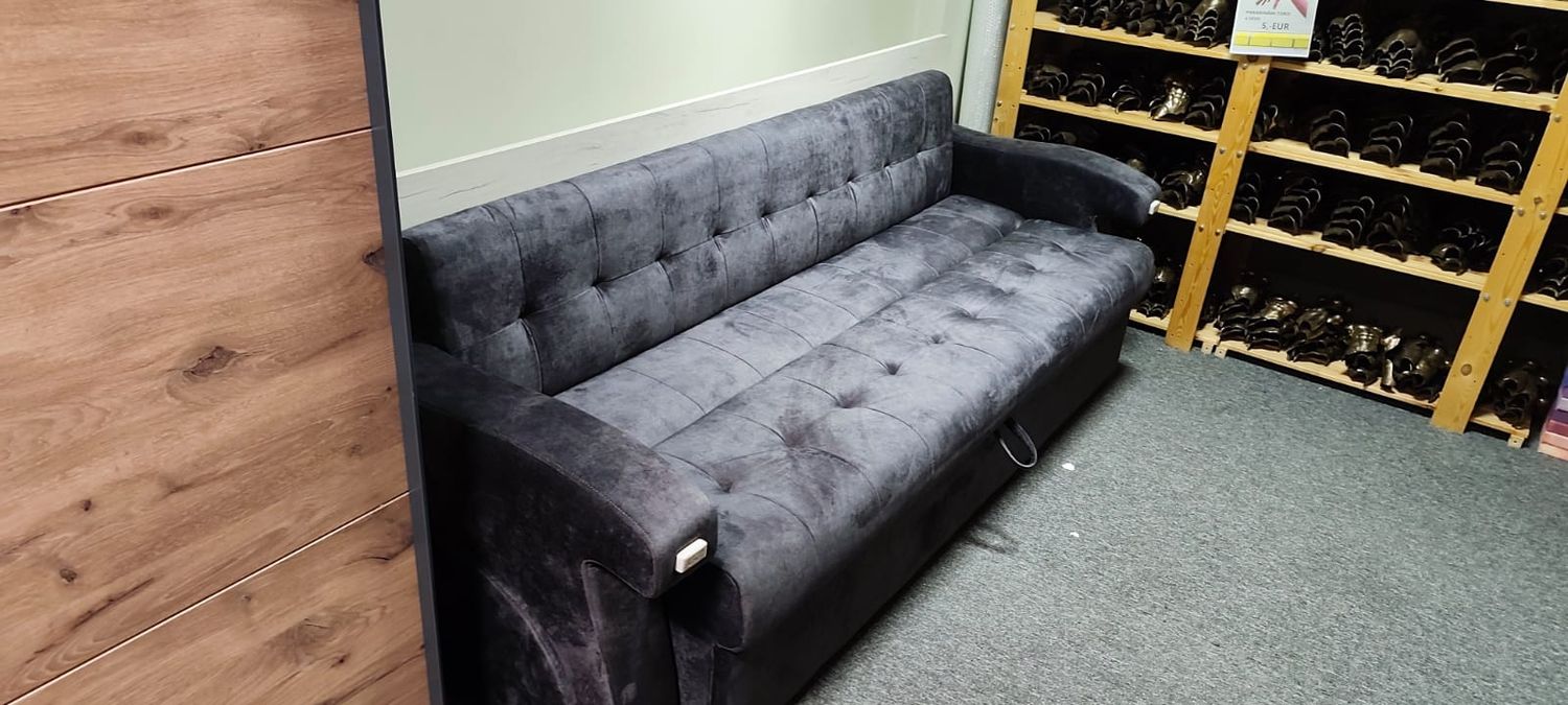 Pull-out sofa bed with a table by Vestern. Gray sofa with a beige table. Multifunctional furniture. Sofas and tables on sale.