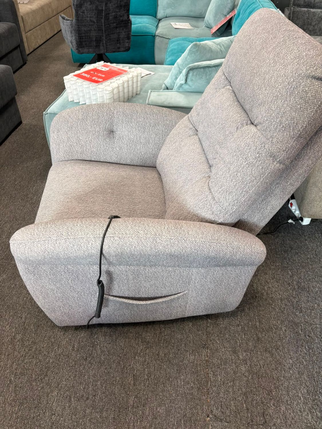 Irisa electric recliner chair in light grey with an adjustable reclining backrest and elevating footrest.