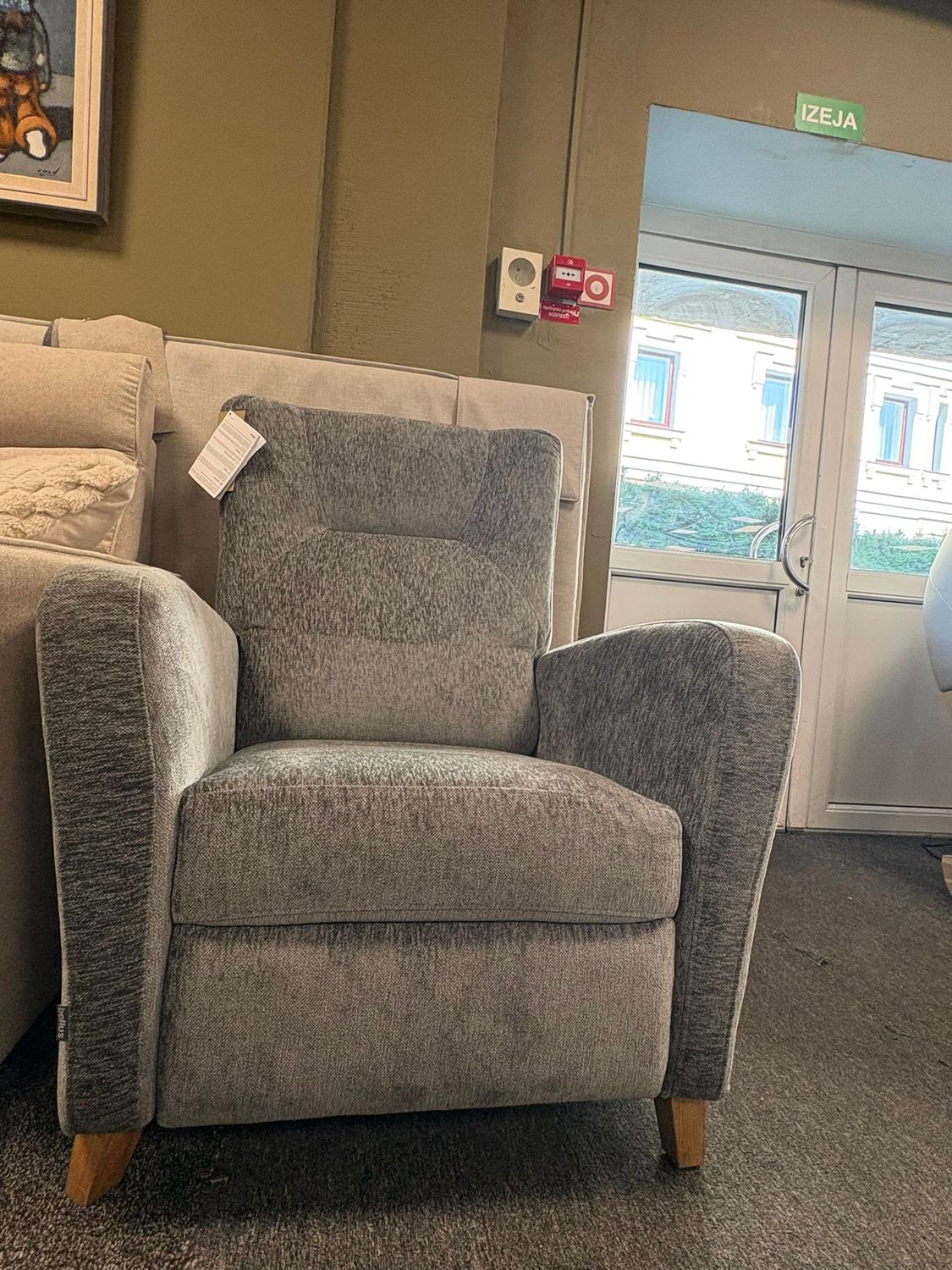 Tampa recliner chair with leg rest function by Bellus, available in various upholstery and wooden leg finishes.