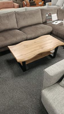 Coffee table with wavy edges, 110 x 60 x 43 cm. Wood-look finish, black legs. Manx Mēbeles furniture store in Jelgava