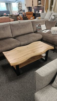 Coffee table with wavy edges, 110 x 60 x 43 cm. Wood-look finish, black legs. Manx Mēbeles furniture store in Jelgava