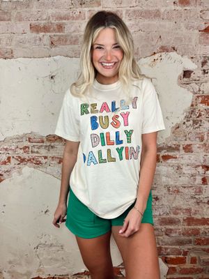 Off white graphic tee with colorful really busy dilly dally text