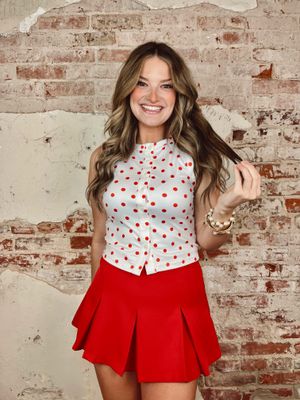 White sleeveless top with red polka dots and button front
