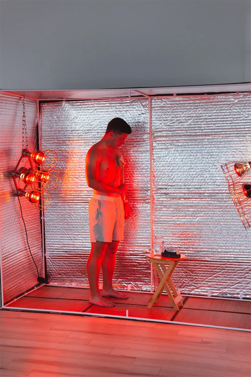 Standing stretch beside the Sauna Fix near infrared lamp