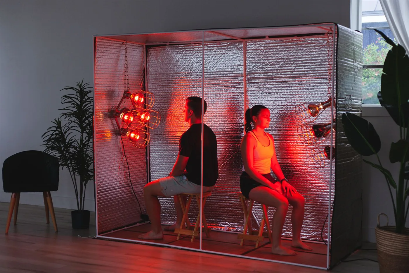 Two people sharing an at-home near infrared sauna session