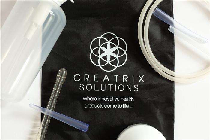 Enema Fix components laid out on the Creatrix Solutions bag