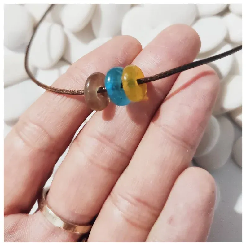 Collar hecho de abalorios de vidrio reciclado. Bonita y simple gargantilla con tres mini donuts de cristal únicos y hechos artesanalmente