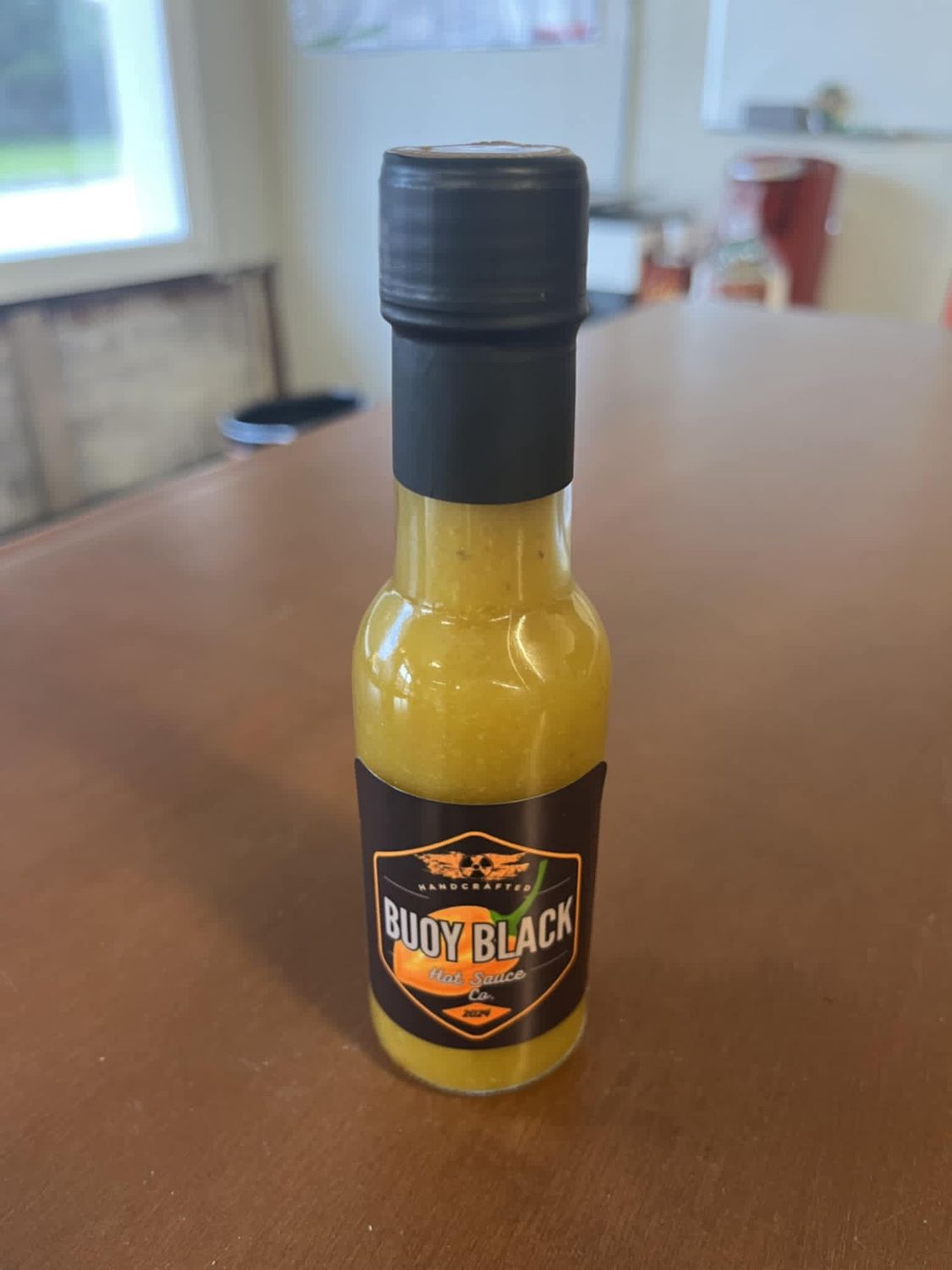 Buoy Black Hot Sauce, Flavor: F.N.G. Jalapeno and Peach