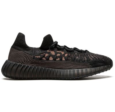 Side view of Adidas Yeezy Boost 350 V2 CMPCT ‘Slate Carbon’ sneaker in black and tan Primeknit with ribbed black sole and sock-like collar
