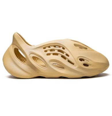 Adidas Yeezy Foam Runner Desert Sand slip-on with oval cutouts and tan foam build