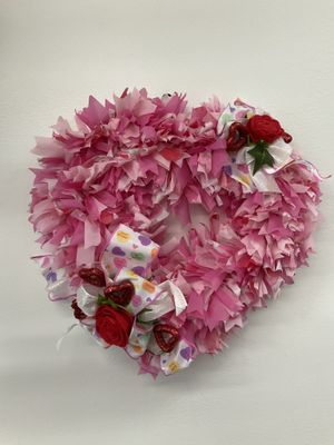 Wreath Heart made from Pink Plastic Tablecloth with Red Hearts and Roses and Candy Ribbon