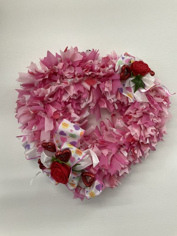 Wreath Heart made from Pink Plastic Tablecloth with Red Hearts and Roses and Candy Ribbon