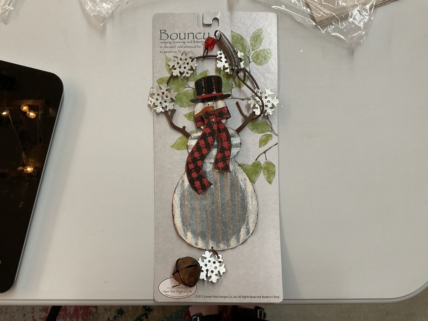 Snowman Bouncy with Red and Black Scarf and holding Snowflakes
