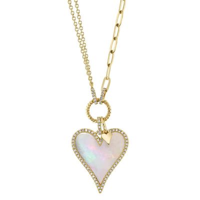 large mother of pearl heart set in 14k yellow gold and accented with 0.20 carats of diamonds