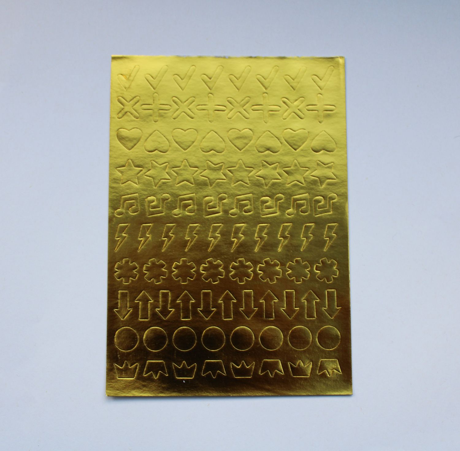 Sheet met gouden stickers in verschillende vormen