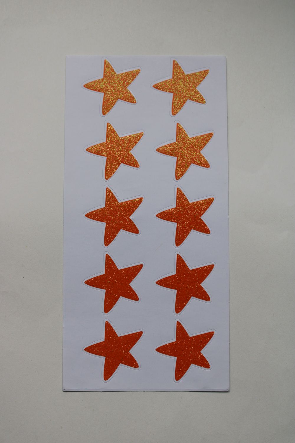 Stickersheet met oranje glitter sterren