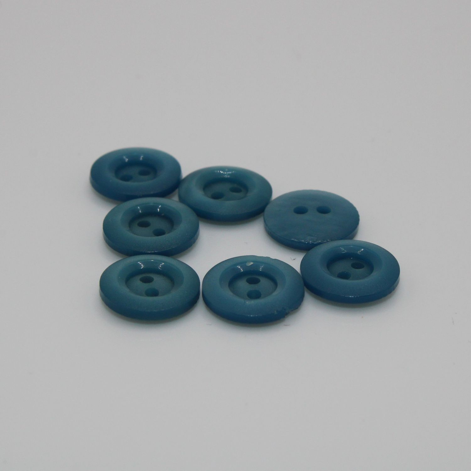 Set van 7 blauwgroene knopen