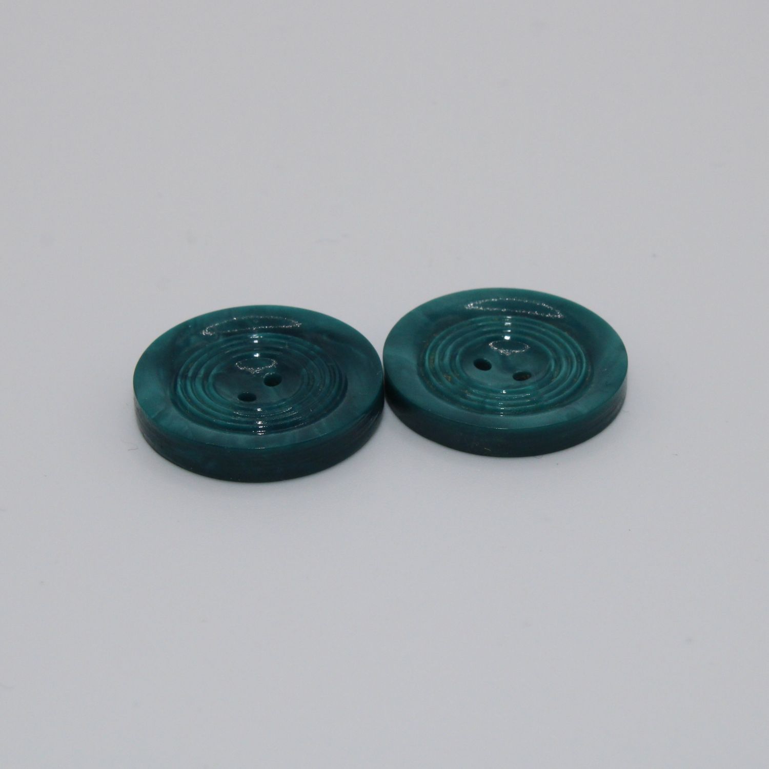 Set van 2 groenblauwe knopen