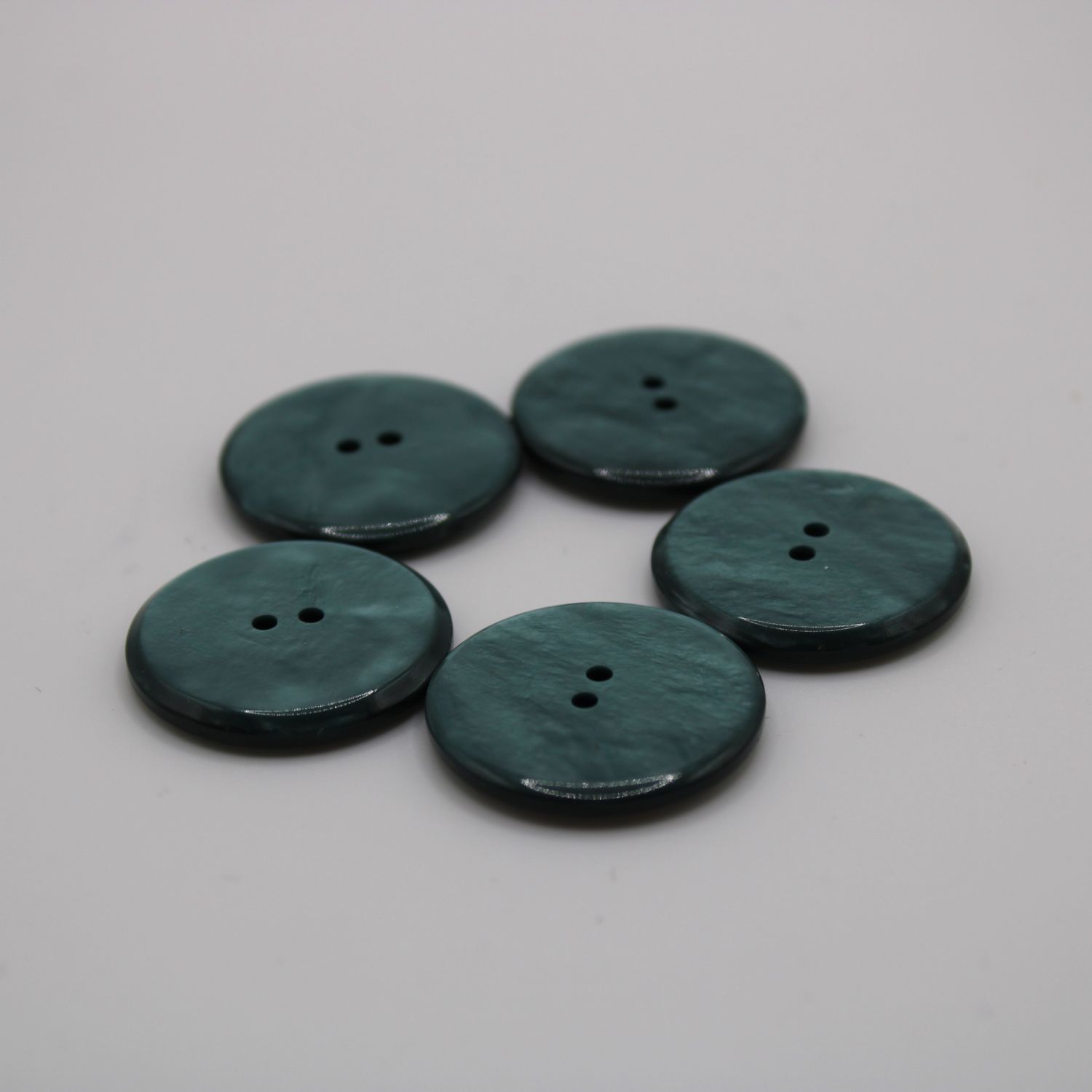 Set van 5 groenblauwe knopen