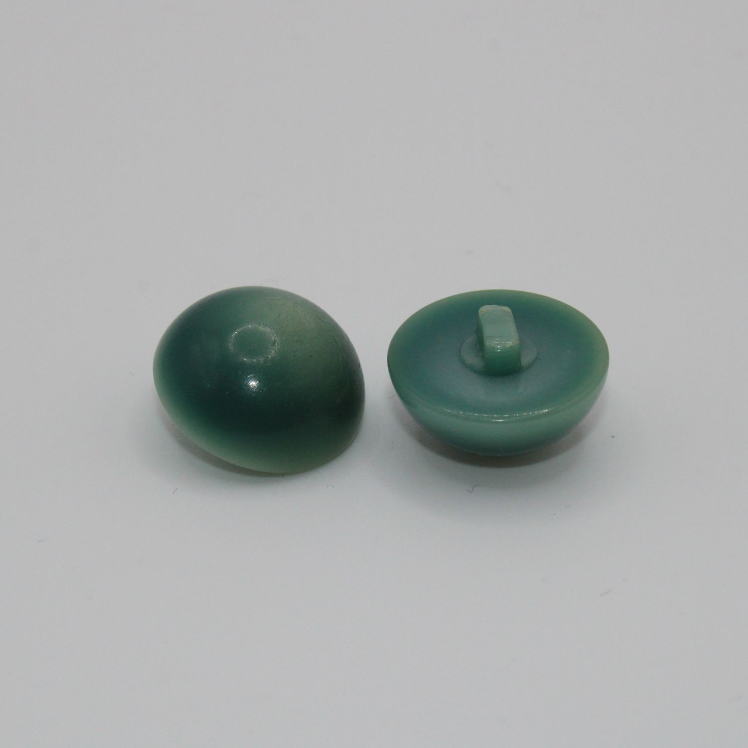 Set van 2 groenblauwe knopen
