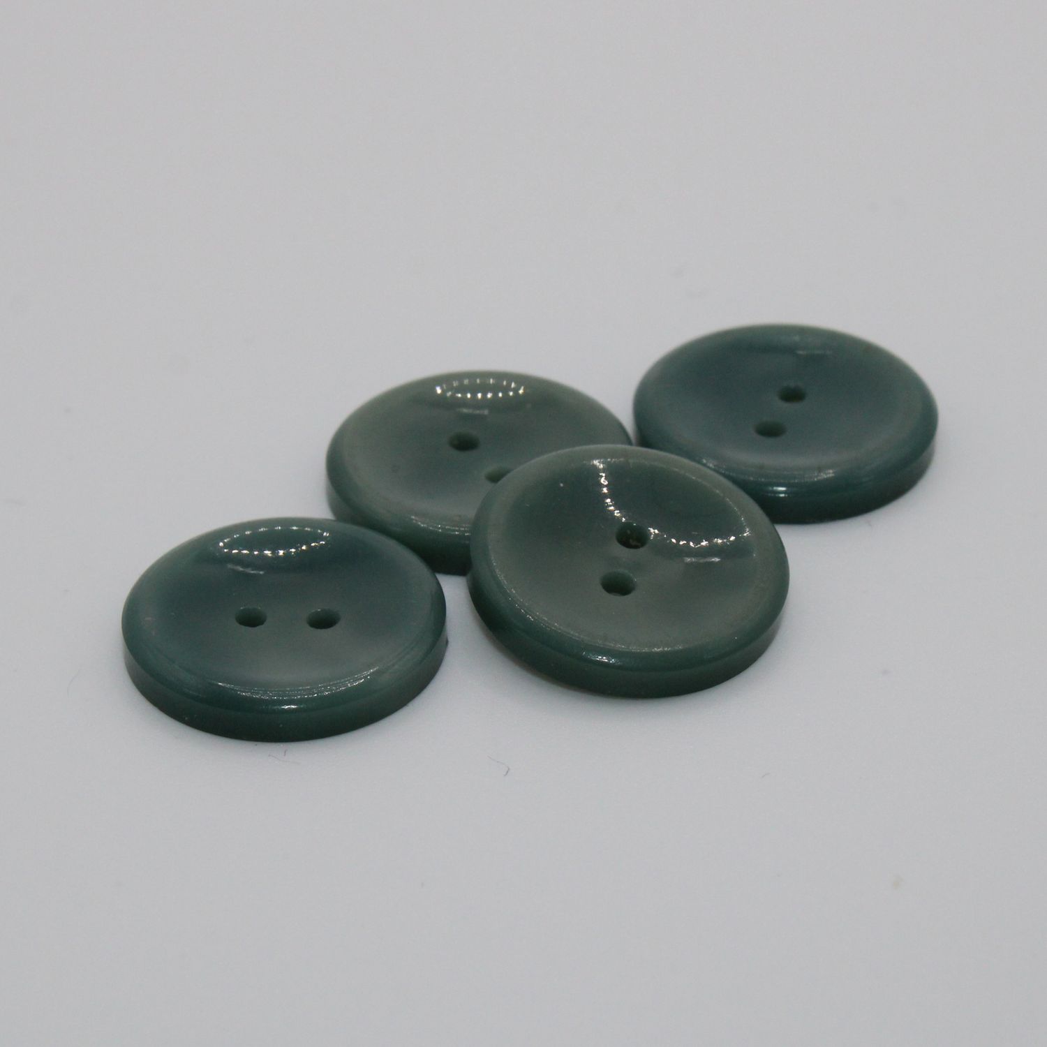 Set van 4 groenblauwe knopen