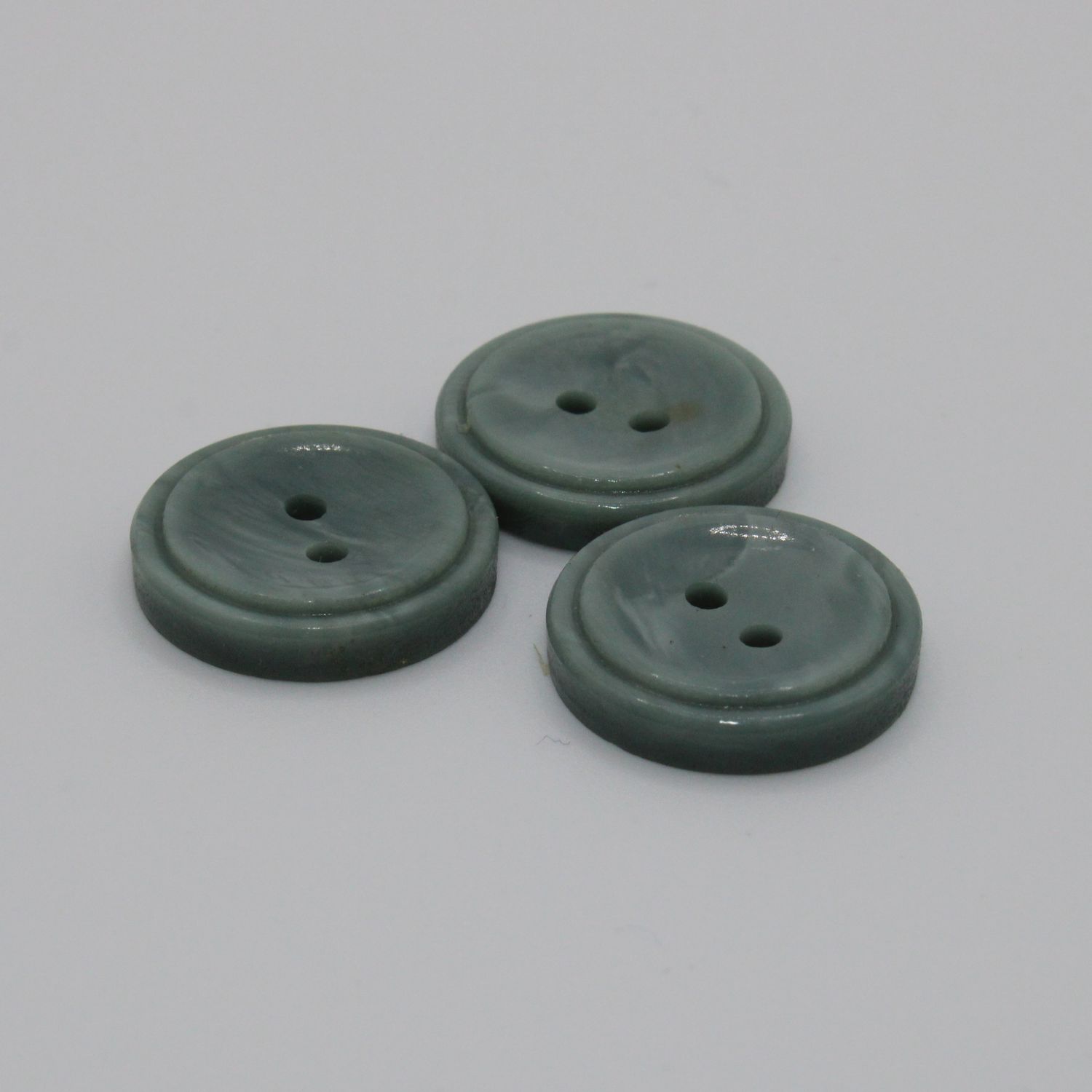 Set van 3 groenblauwe knopen