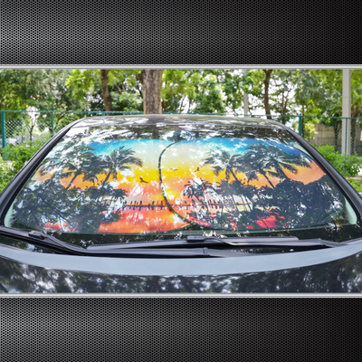 Auto Drive Universal Automotive Windshield Twist Sunshade 2-Pack, featuring a vibrant sunset palm tree design, silver heat-reflective back, and foldable design for easy storage. Size 28.5" x 31.5", universal fit for most vehicles.