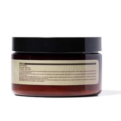 An amber-colored jar labeled “Solo Noir Sleek 2-in-1 Moisturizing Shave Cream,” featuring a black lid and a creamy, off-white formula inside