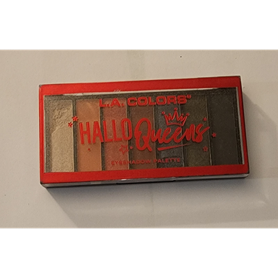 A rectangular L.A. COLORS “Hallo Queens” eyeshadow palette with a red border, featuring multiple neutral and shimmery shades, sealed in its original packaging.