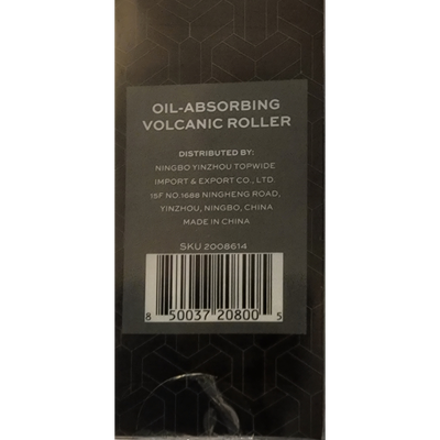 A rectangular black box with geometric patterns showcasing a handheld oil-absorbing volcanic roller. The roller’s black handle and beige volcanic stone ball are partially visible through clear plastic packaging, accompanied by text reading “Oil-Absorbing Volcanic Roller” and product details on the front and back.
