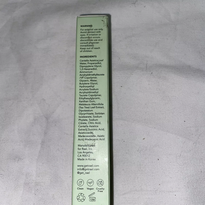 A small, rectangular, mint-green box labeled “Rael Beauty Miracle Clear Soothing Spot Gel” standing upright against a neutral background. The box features minimal text and simple graphics, indicating key ingredients and usage instructions.