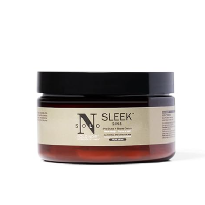 An amber-colored jar labeled “Solo Noir Sleek 2-in-1 Moisturizing Shave Cream,” featuring a black lid and a creamy, off-white formula inside
