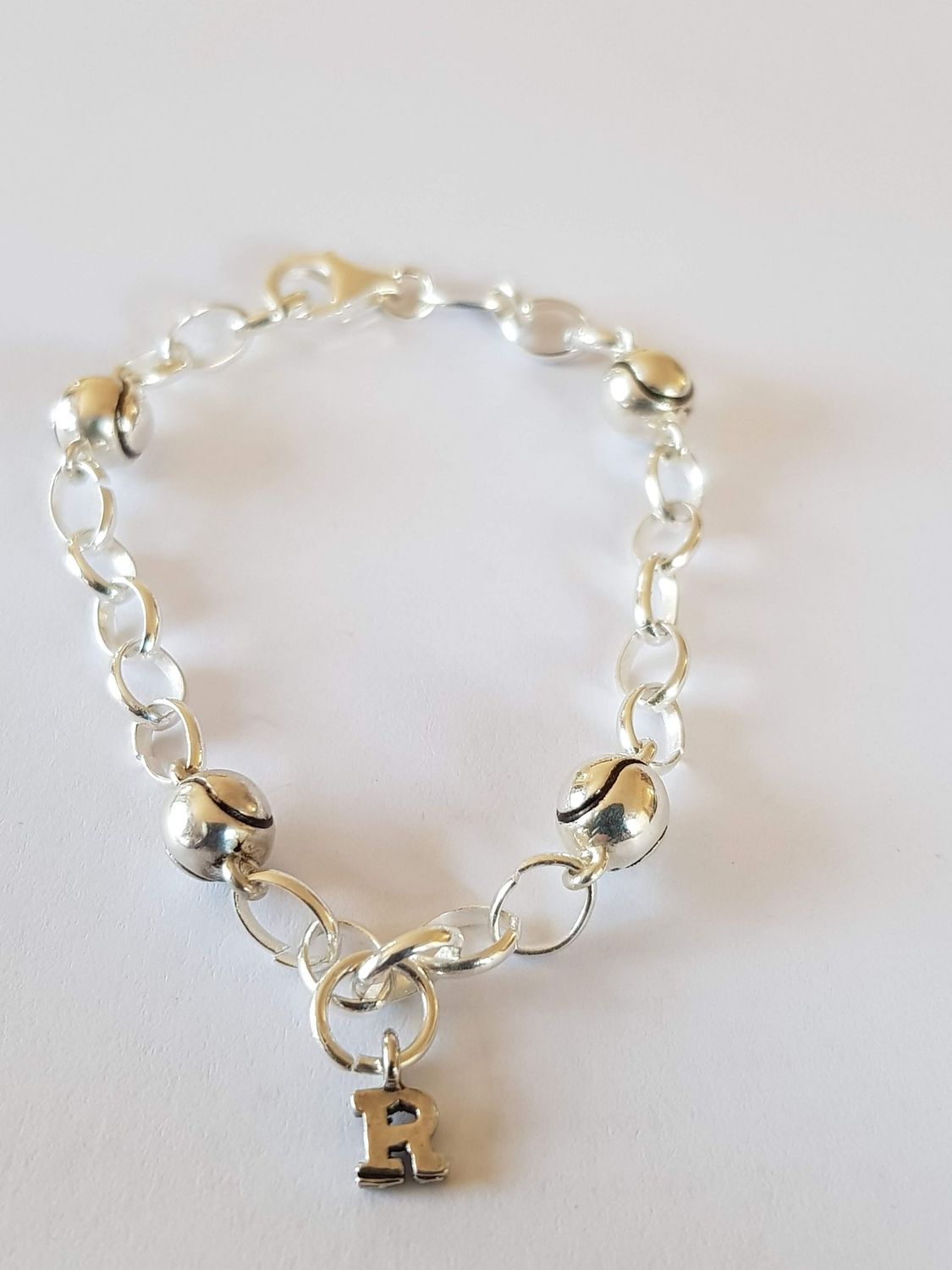 Silver bracelet with 4 silver tennis balls