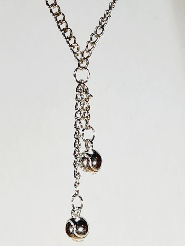 Silver necklace with two hanging silver tennis balls