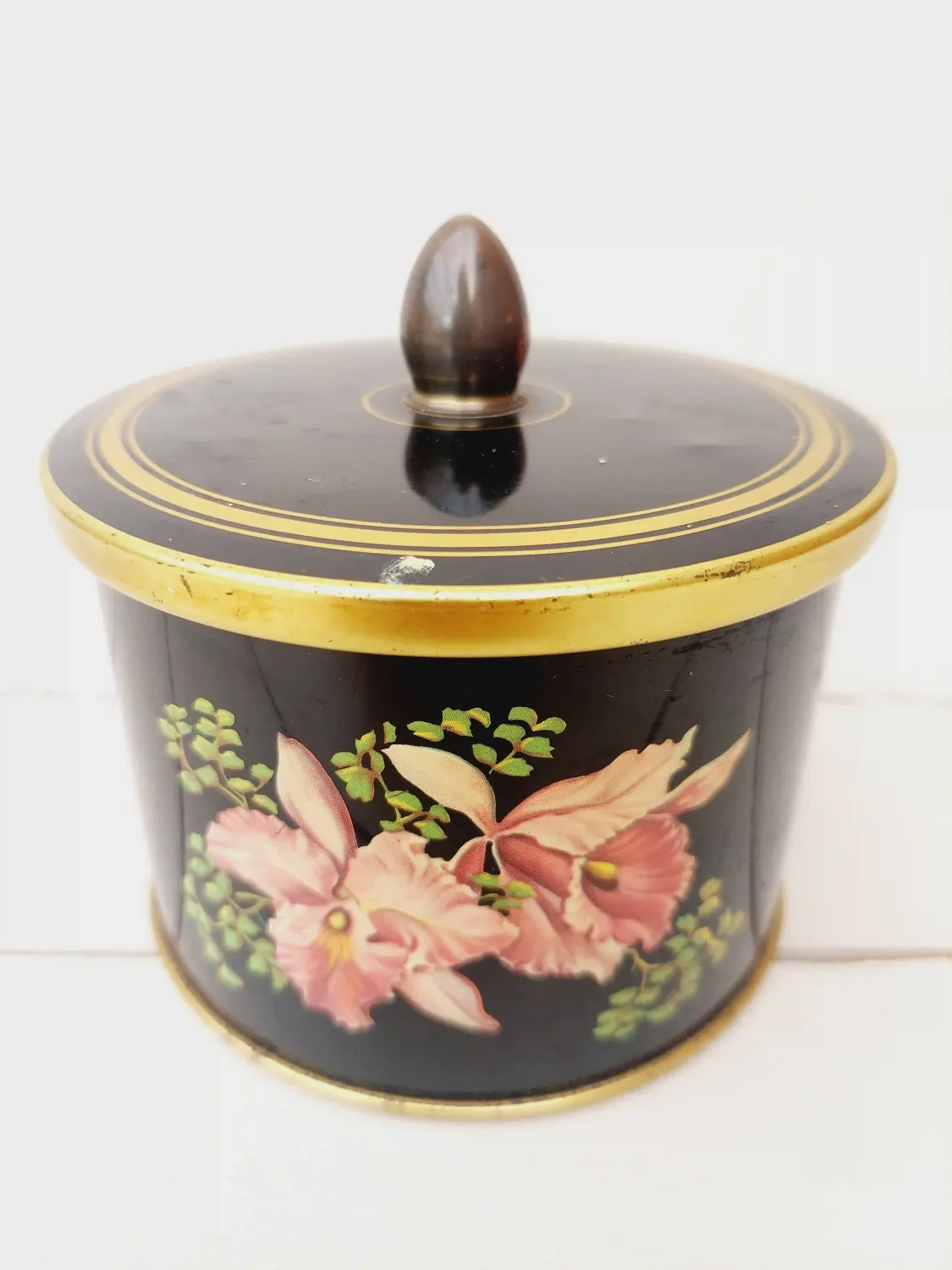 Vintage blik Cote d'Or, rond, zwart met bloemendecoratie en gouden randen
