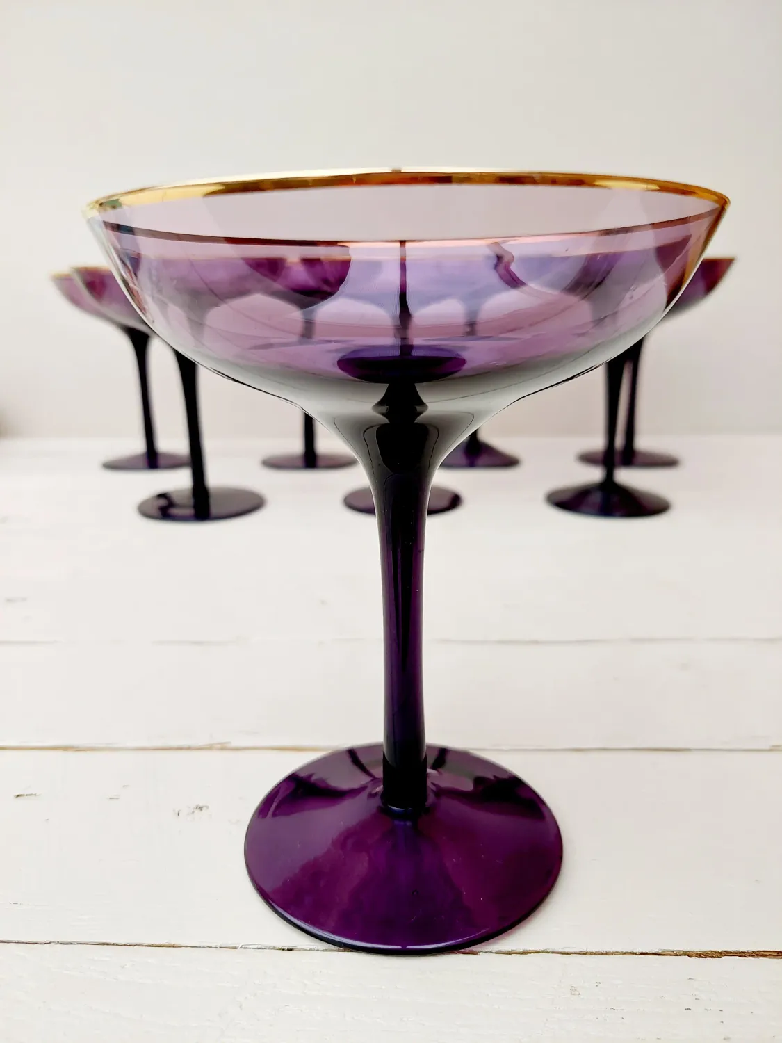 Decoratieve glazen in auberginekleur, mondgeblazen met zichtbare luchtbelletjes. 