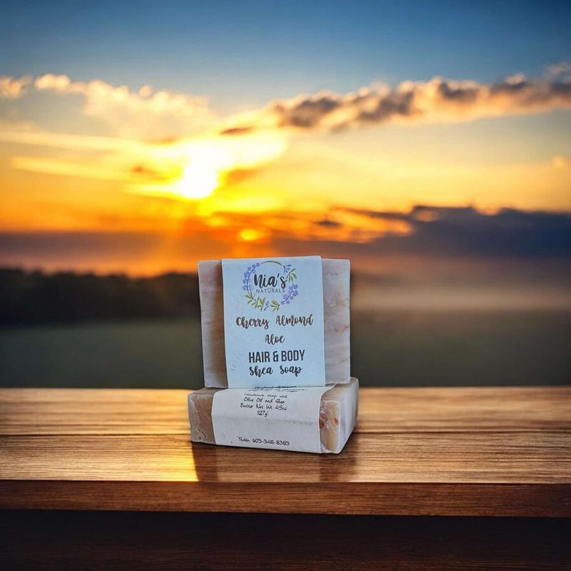 A Nia's Naturals Cherry Almond Aloe Hair & Body Vegan Bar sits before a beautiful Vermont sunset
