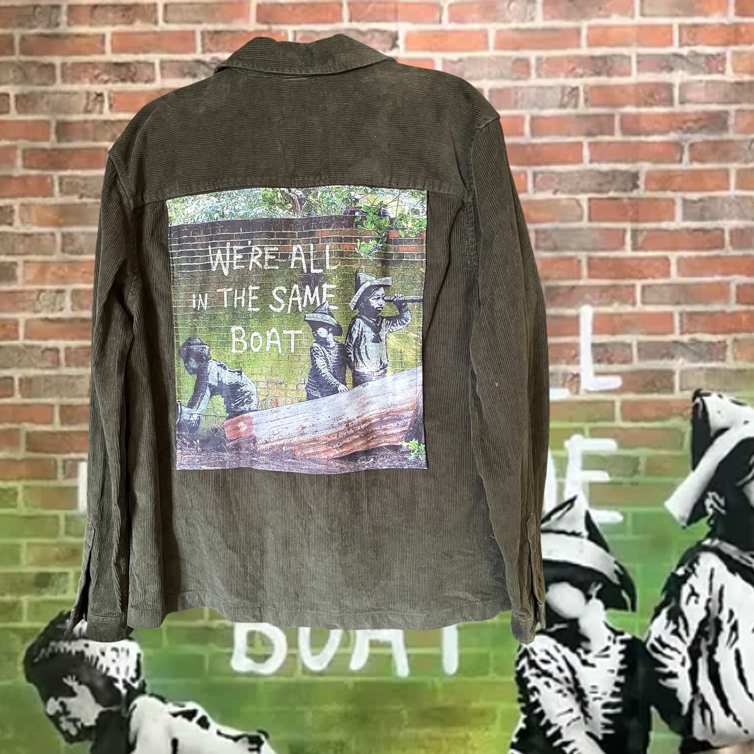Veste velours Banksy – "We're All in the Same Boat"
