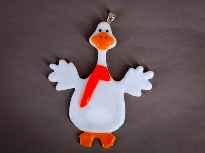 Hvid glasgås med orange næb og klart julerødt tørklæde.