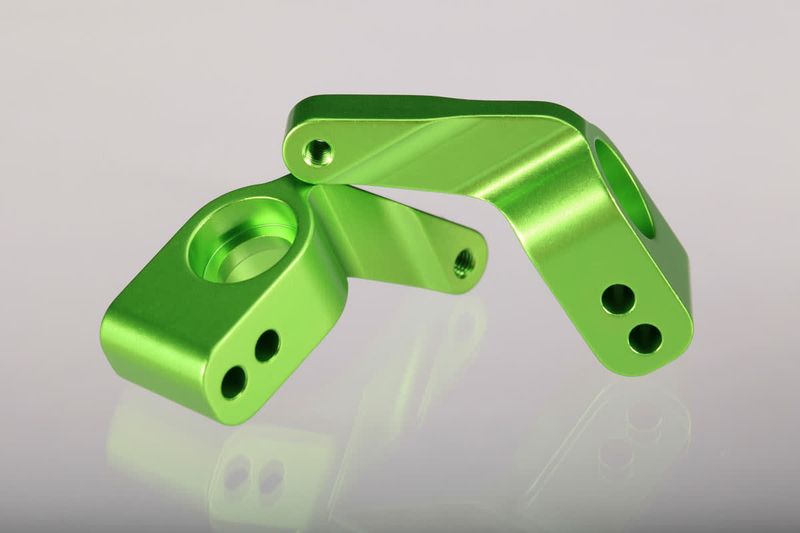 TRA3652G Traxxas Stub axle carriers, Rustler/Stampede/Bandit (2), 6061-T6 aluminum (green-anodized)/ 5x11mm ball bearings (4)