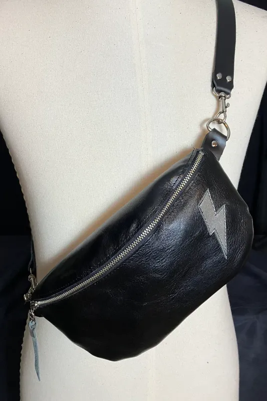 Body pouch displayed on a mannequin - featuring the leather texture (slightly shiny) and silver lightening bolt on front
